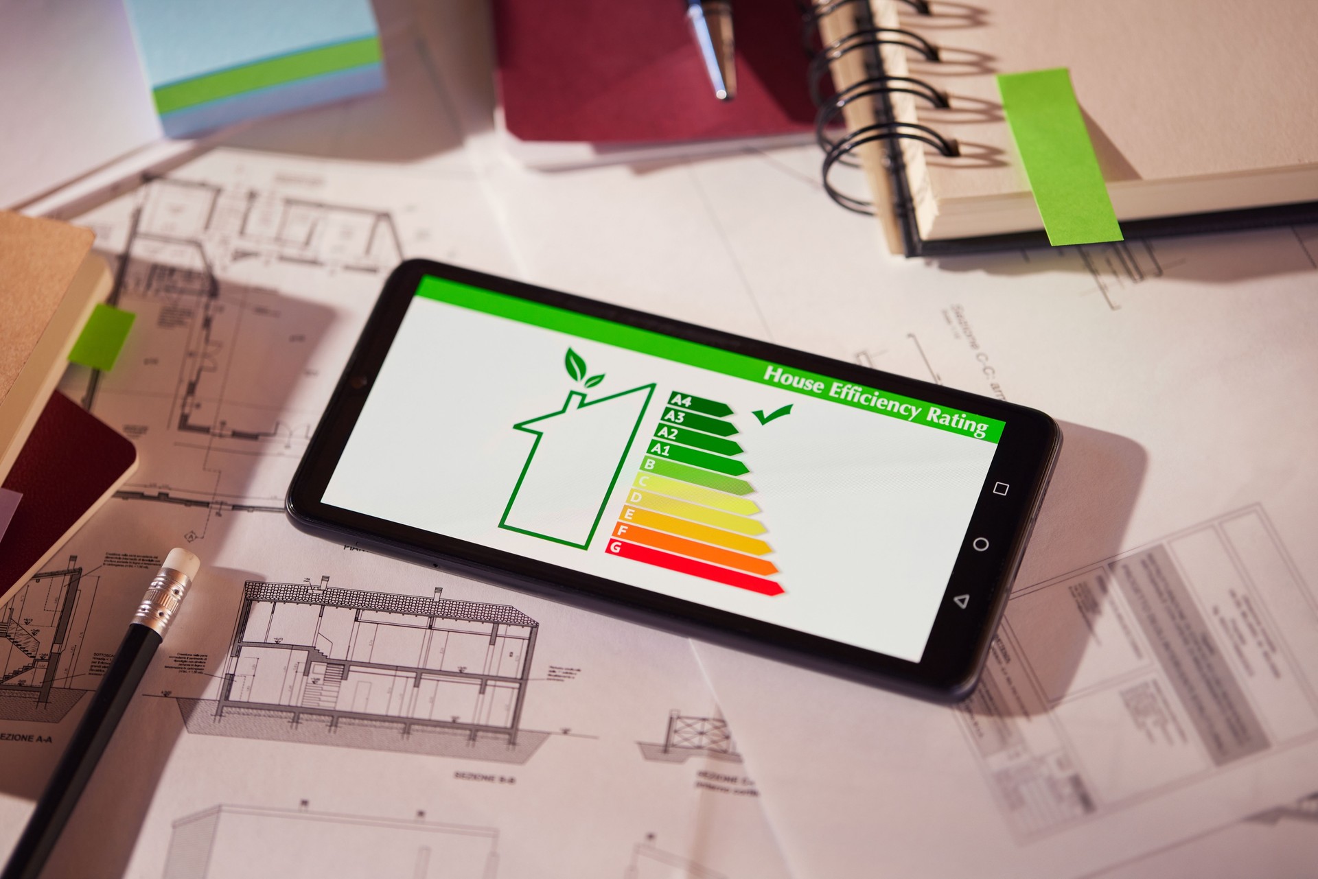 Energy efficiency mobile app on screen. Closeup of detail of house efficiency rating on mobile phone. Home efficiency reading app on mobile phone kept on desk.