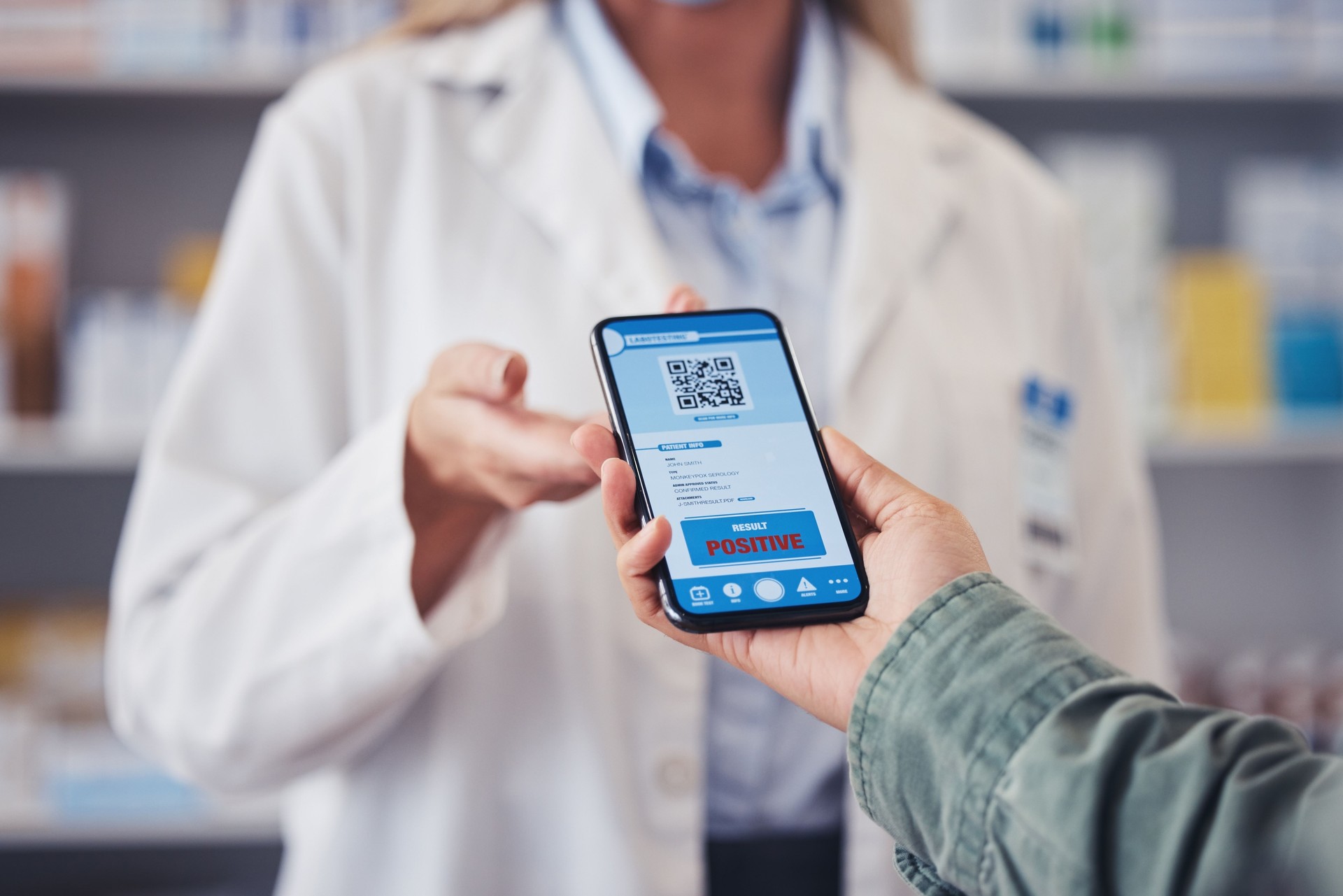 Pharmacist, customer and hands with phone, qr code or positive diagnosis of monkeypox virus at pharmacy. Closeup of medical worker and patient on mobile smartphone app for test results at drugstore